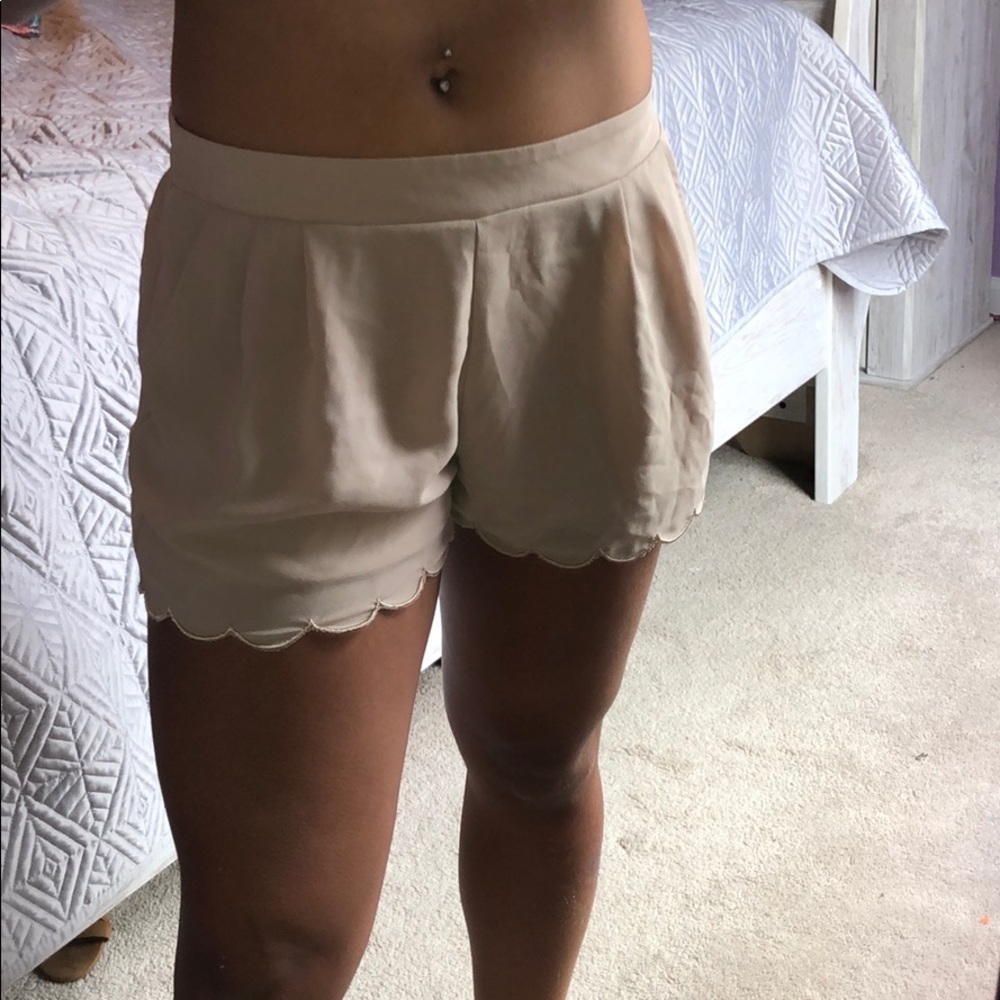 •Tan scalloped shorts•